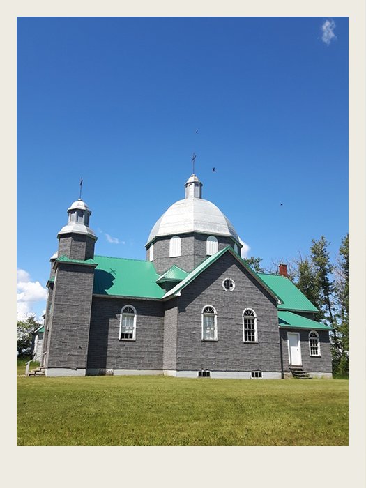 A man is selling newspapers. The newspaper says ‘The Globe and Mail – Canada Declares War’ on the front of it.