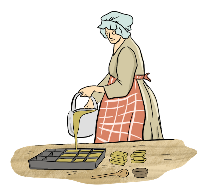 A woman is pouring liquid into a soap mold to let the soap harden into rectangles. 