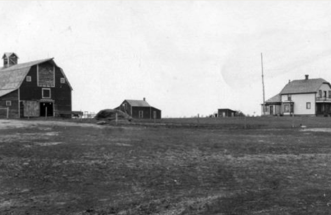 A homestead with a wood farmhouse, a couple of sheds, and a large barn are being highlighted.