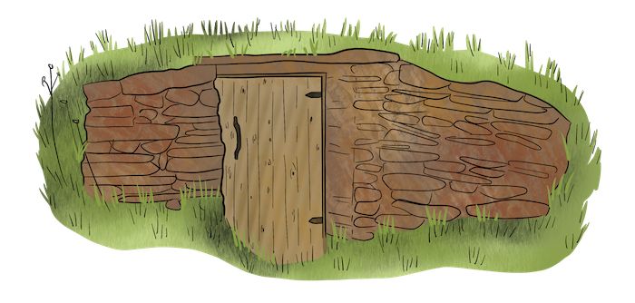 This root cellar is built into the side of a hill with stones and a wooden door. 