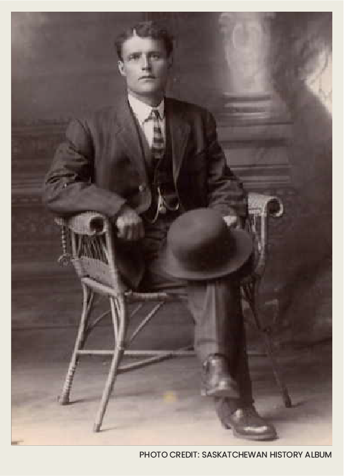 A man with a nice suit on is sitting in a chair with his legs crossed. 