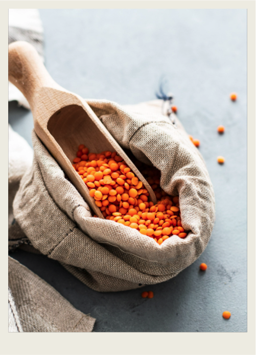 Red lentils A bag of lentils is shown with a scoop in it.