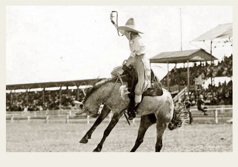 Three men are casually standing around outside of a log home.