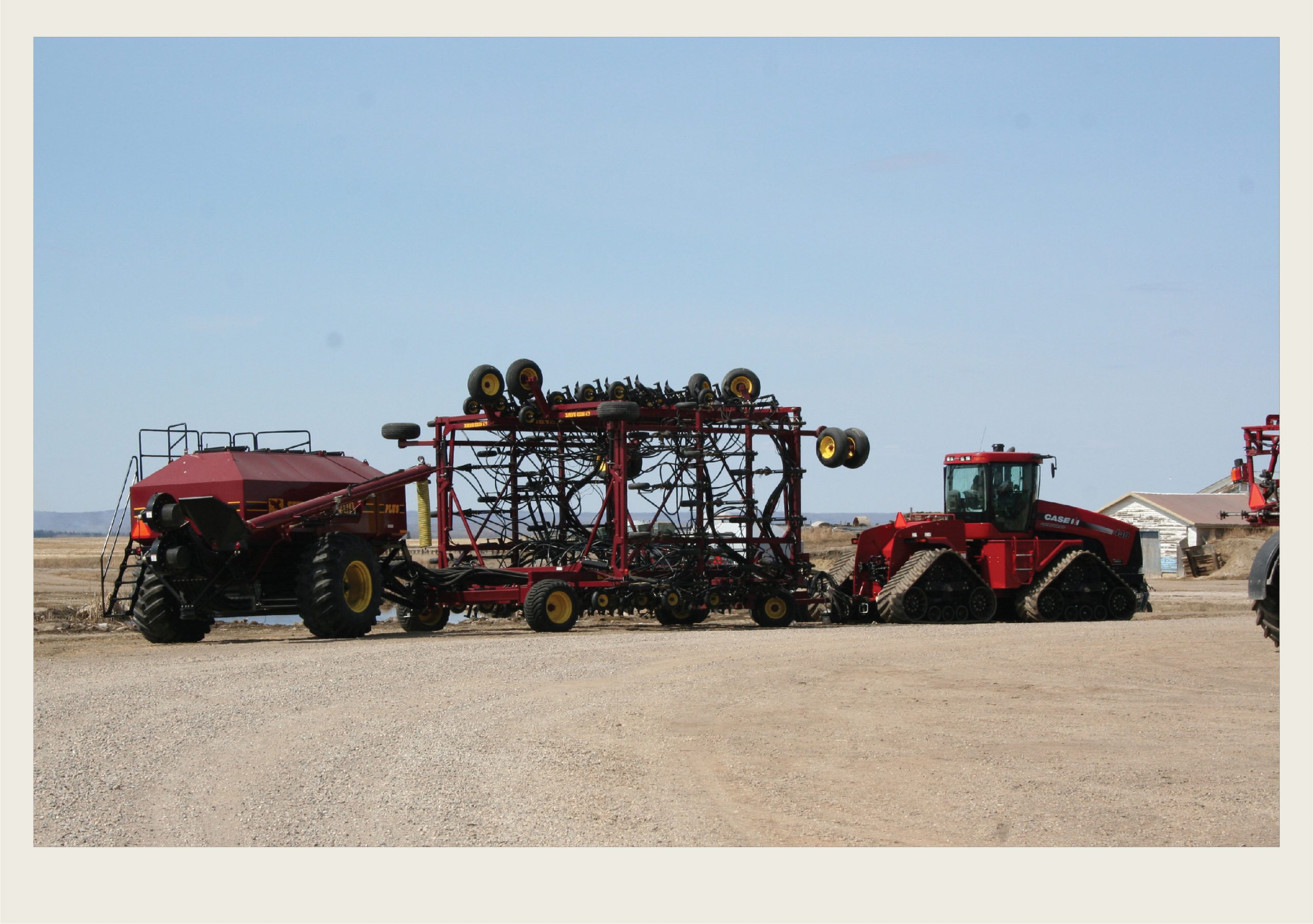 Past-Immigration-Hutterites-Culture (HeartofSK) A modern tractor pulls an air seeder.