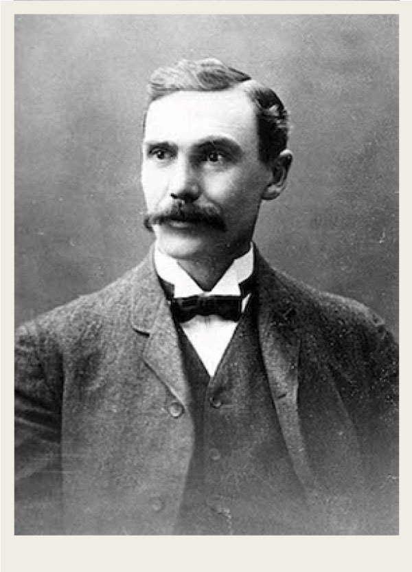 A painting of Walter Scott is shown. He is sitting and looking at the painter. He wears a suit.