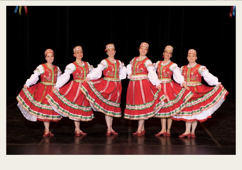 Six women are dressed up in traditional Ukrainian outfits for dancing.