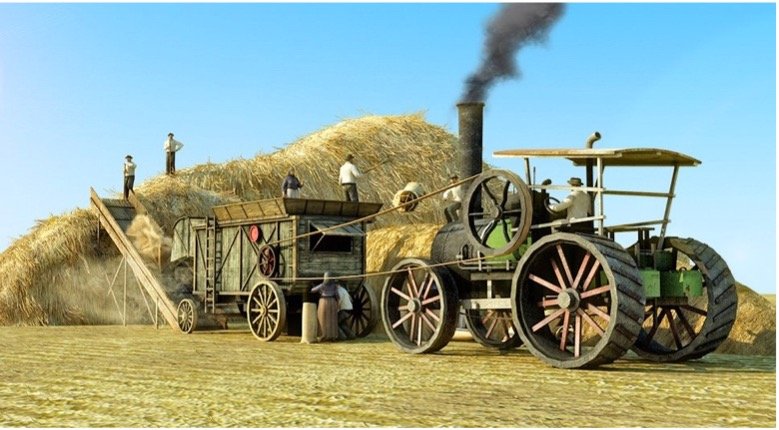A threshing crew works on a threshing machine to harvest a large pile of grain.