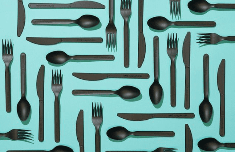 Evolution-FutureofFarming-FutureofByproducts-Bioplastics-Overview A grouping of plastic cutlery that has been arranged neatly sits on a countertop.