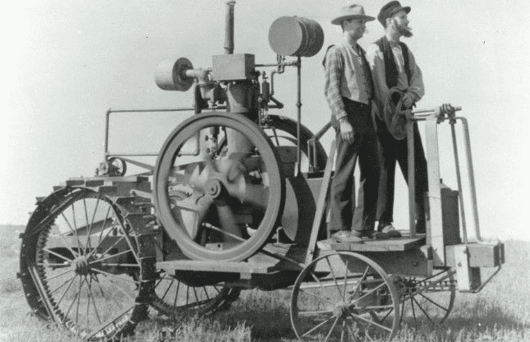 A drawing of a gas tractor is shown with steel tires on a frame with an engine on it.