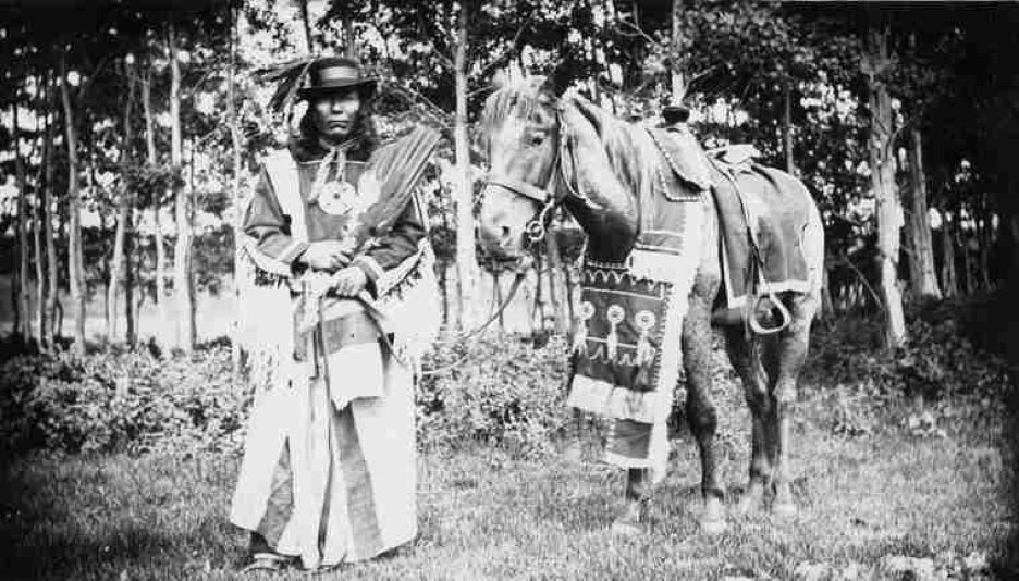 A piece of art by Leah Marie Dorion made with mosaics shows a bison with a circle around it. There are other smaller bison on the edges of the artwork.