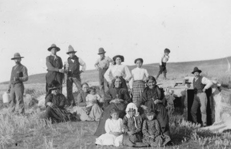A large group of people together in a field.
