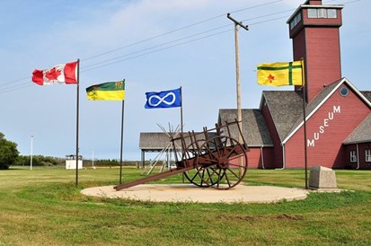 An Illustrated york boat travels on a river with four fur traders and some goods to trade to the First Nations people.