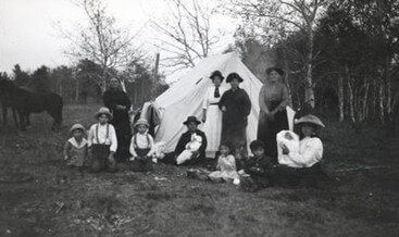 A piece of art by Leah Marie Dorion made with mosaics shows two Indigenous women facing each other with their hair blowing out behind them. There is a sun with butterflies in the centre, and snakes underneath the ground.