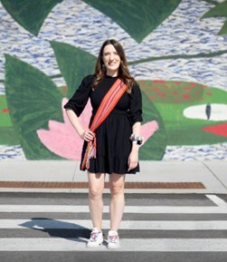 A piece of art by Leah Marie Dorion made with mosaics shows two Indigenous women facing each other with their hair blowing out behind them. There is a sun with butterflies in the centre, and snakes underneath the ground.