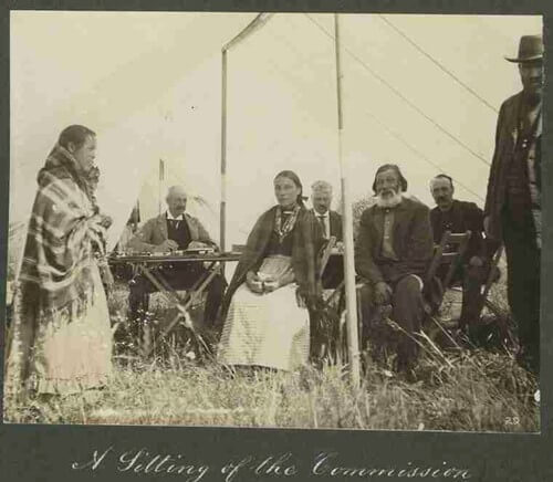 A piece of art by Leah Marie Dorion made with mosaics shows two Indigenous people standing near animals, sun, and water.